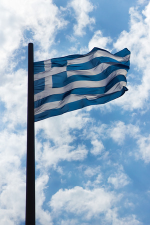 Greek flag on the blue skyの写真素材
