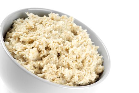 Bowl of porridge on white background. Healthy breakfastの写真素材