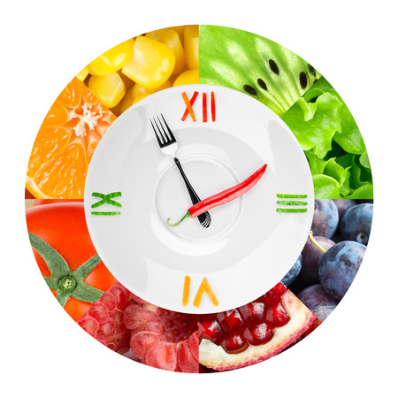 Food clock with fruits and vegetables. Healthy food conceptの写真素材