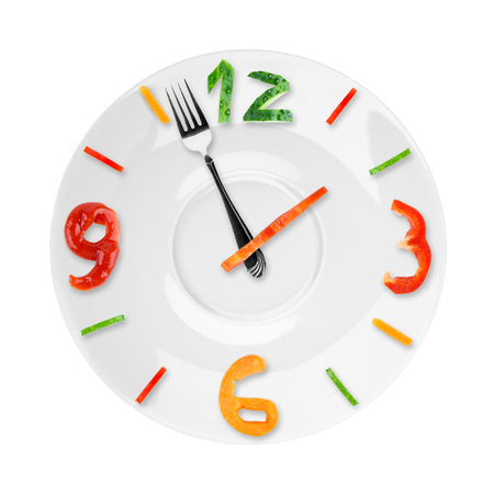 Food clock on white background. Healthy food conceptの写真素材