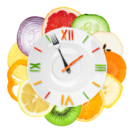 Food clock with  sliced vegetables and fruits. Healthy food conceptの写真素材