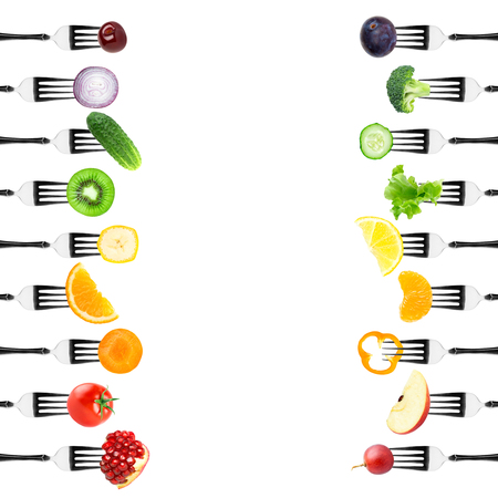 Color fruits and vegetables on fork on white background. Food conceptの写真素材