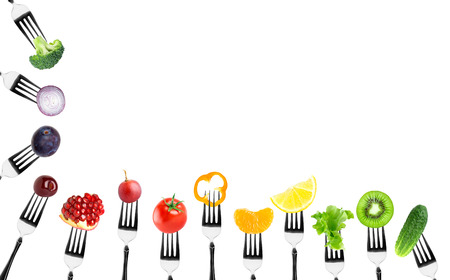 Fruits and vegetables on fork on white backgroundの写真素材