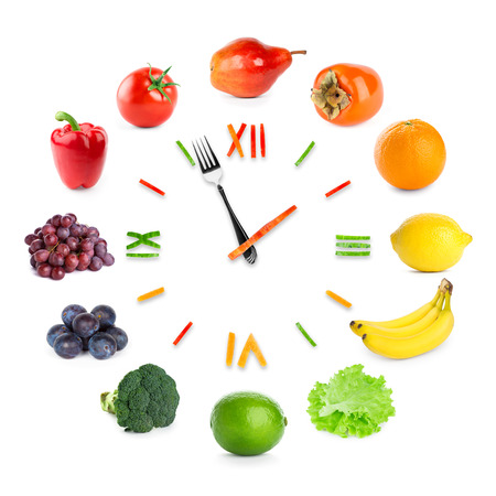 Food clock with fruits and vegetables on white background. Food conceptの写真素材