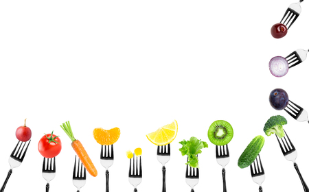 Fruits and vegetables on fork on white background. Food conceptの写真素材