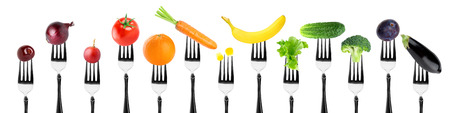 Fruits and vegetables on fork on white background. Food conceptの写真素材