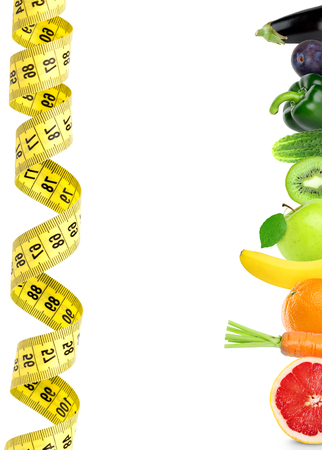 Fresh fruit and vegetable with measuring tape on white background. Diet concept. Healthy foodの写真素材