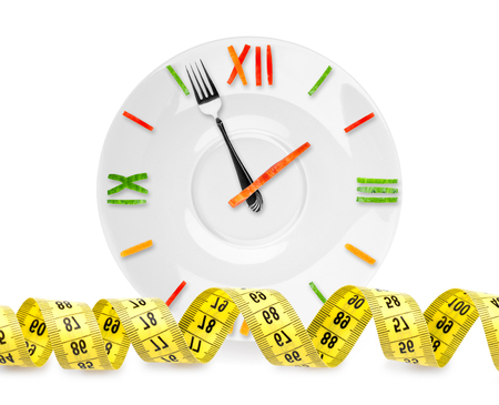 Food clock with measuring tape on white background. Diet conceptの写真素材