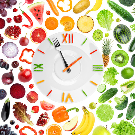 Food clock with fruits and vegetables on white background. Diet conceptの写真素材