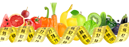 Fresh fruit and vegetable with measuring tape on white background. Diet conceptの写真素材