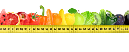 Fresh fruit and vegetable with measuring tape on white background. Diet conceptの写真素材