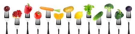 Fruits and vegetables on fork on white background. Food conceptの写真素材