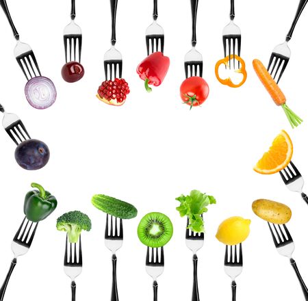 Fruits and vegetables on fork on white background. Food conceptの写真素材