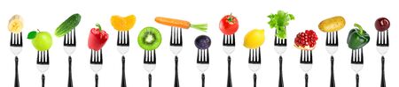 Fruits and vegetables on fork on white background. Food conceptの写真素材