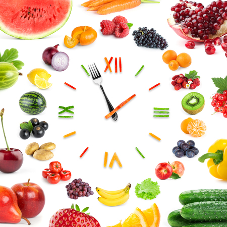 Food clock with fruits and vegetables. Healthy foodの写真素材