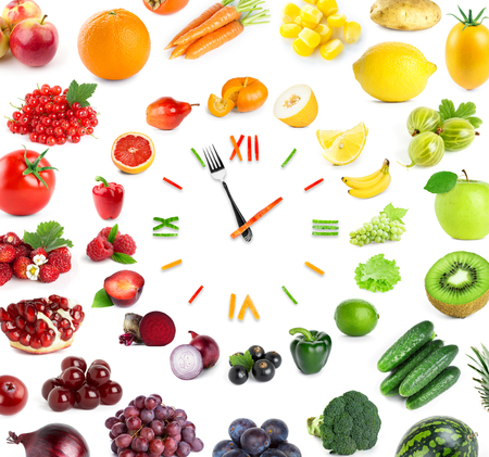 Food clock with fresh fruits and vegetables. Healthy foodの写真素材