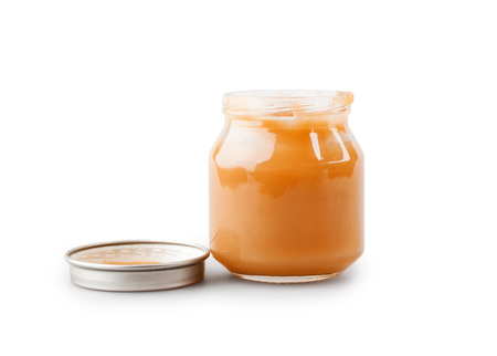 Baby food on white background. Fruit puree in glassの写真素材