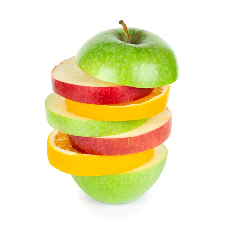 Fresh fruits. Stack of apple and orange slices on white backgroundの写真素材
