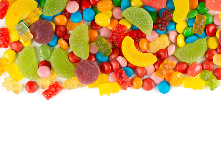 Mixed colorful candies. Color sweets on white background. Top viewの写真素材