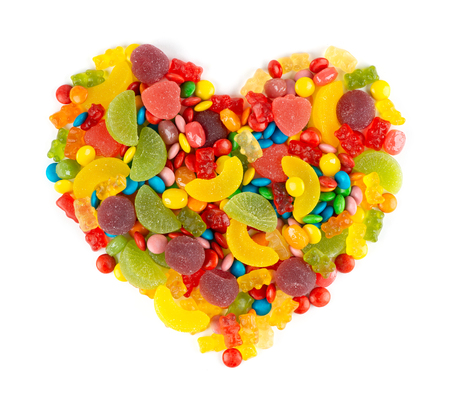 Mixed colorful candies. Heart of color sweets on white backgroundの写真素材