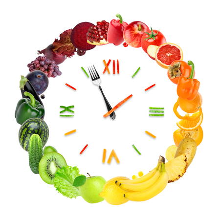 Food clock with fresh fruits and vegetables. Healthy foodの写真素材