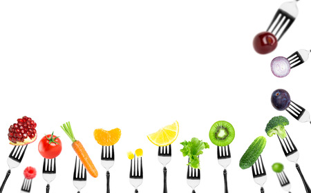 Fruits and vegetables on the forks. Healthy foodの写真素材