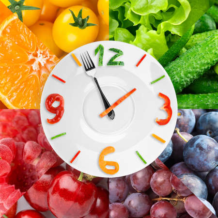 Food clock with fresh fruits and vegetables. Healthy foodの写真素材