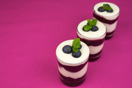 Dessert of creamy  yoghurt with layers of cherry jelly.の写真素材