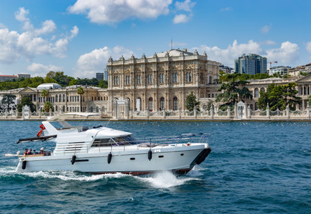 Yacht on a Dolmabahce Palace background in Istanbul, Turkey.のeditorial素材
