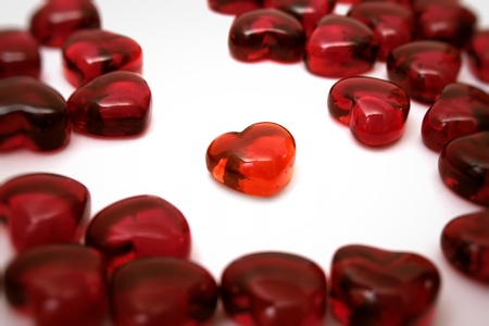 Bright red heart on a white background among others heartsの写真素材