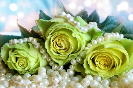 Bouquet of white roses lying on the pearl