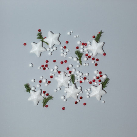 Creative layout made of white stars and other christmas decorations. Minimal flat lay concept.の写真素材