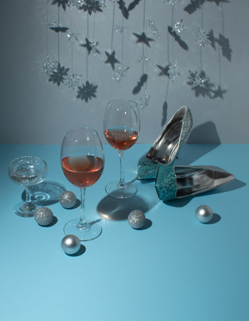 New year table for celebration with shoes, plates and glasses on blue and  gray background. Minimal concept.の写真素材