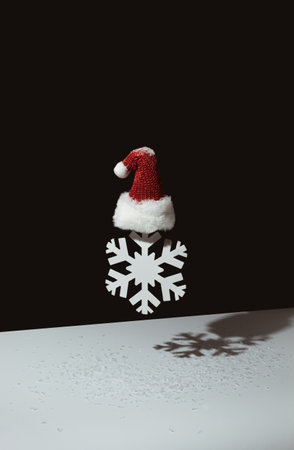 3D render of snowflake with minimalistic Santa's hat on black and white background. Contemporary style.の写真素材