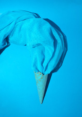 Vintage style concept with ice cream cones and blue mesh fabric. Monochromatic background. Retro fashion aesthetic.の写真素材