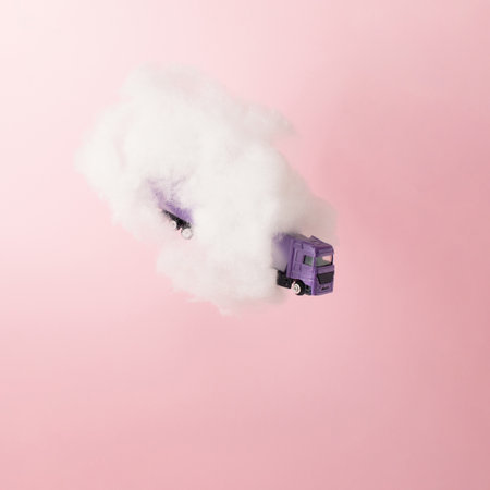 Purple truck in cloud on pink background. Growth, future, development concept. Minimal pink compostition.の写真素材