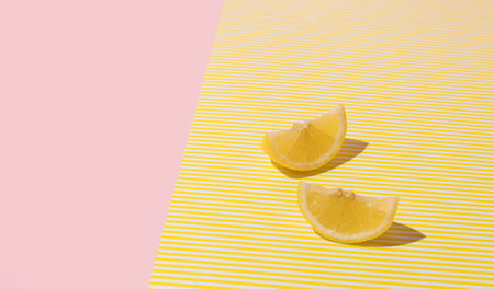 Creative summer layout made of lemon on yellow and bright pastel pink background. Citrus fruit minimal concept.の写真素材