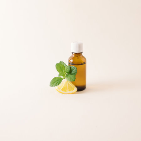 Bottle of lemongrass essential oil with fresh slice of lemon and lemongrass leaves on a white background. Relaxsation concept.の写真素材