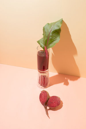 Red beet, leaf and beet juice in a glass. Minimal healthy composition. Close-upの写真素材