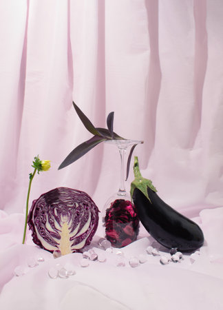 Creatively arranged eggplant and purple cabbage against light violet background. Healthy food concept. Still lifeの写真素材
