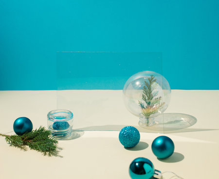 Creative arrangement turquois blue Christmas baubles decoration on blue and white background. Minimal New Year concept.の写真素材