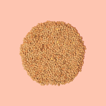 Top view of uncooked lentil against peaches background. Food conceptの写真素材