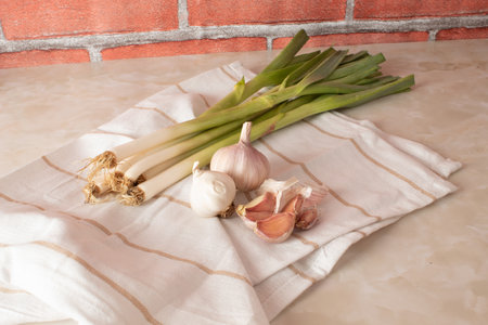 Creative arrangement with organic garlic on marble kitchen table. Healthy food concept