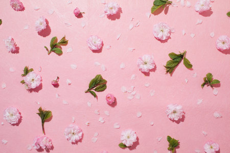Pink flower pattern on pink pastel background. Minimal spring concept. Flat lay.