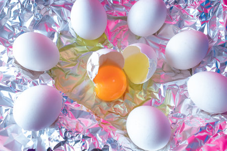 White fresh egg with colorful ultraviolet holographic neon lights. Creative concept.の写真素材
