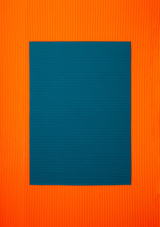 Orange and blue corrugated paper background suitable for cardsの写真素材