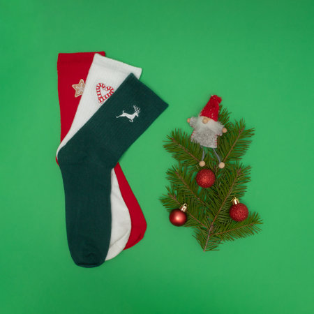 Christmas red, green and white socks with evergreen branches and Christmas ornamentsの写真素材