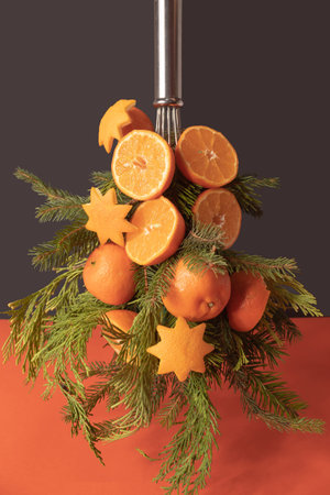 Christmas tree made of orange fruit and evergreen branchesの写真素材