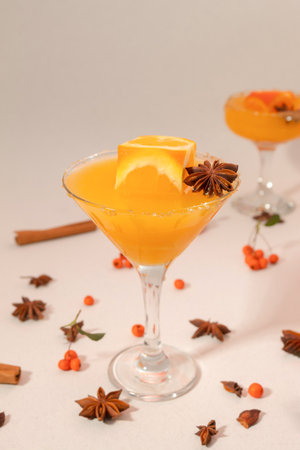 Orange juice in high glass with orange cube and spicesの写真素材
