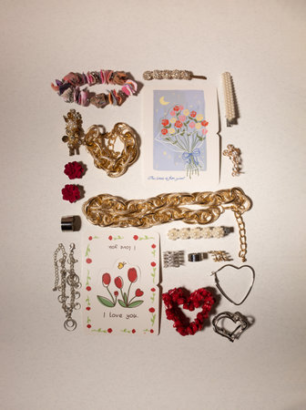 Heart-shaped jewellery and accessory on a light background. Flat lay, top view. Fashion concept for Valentine's Dayの写真素材